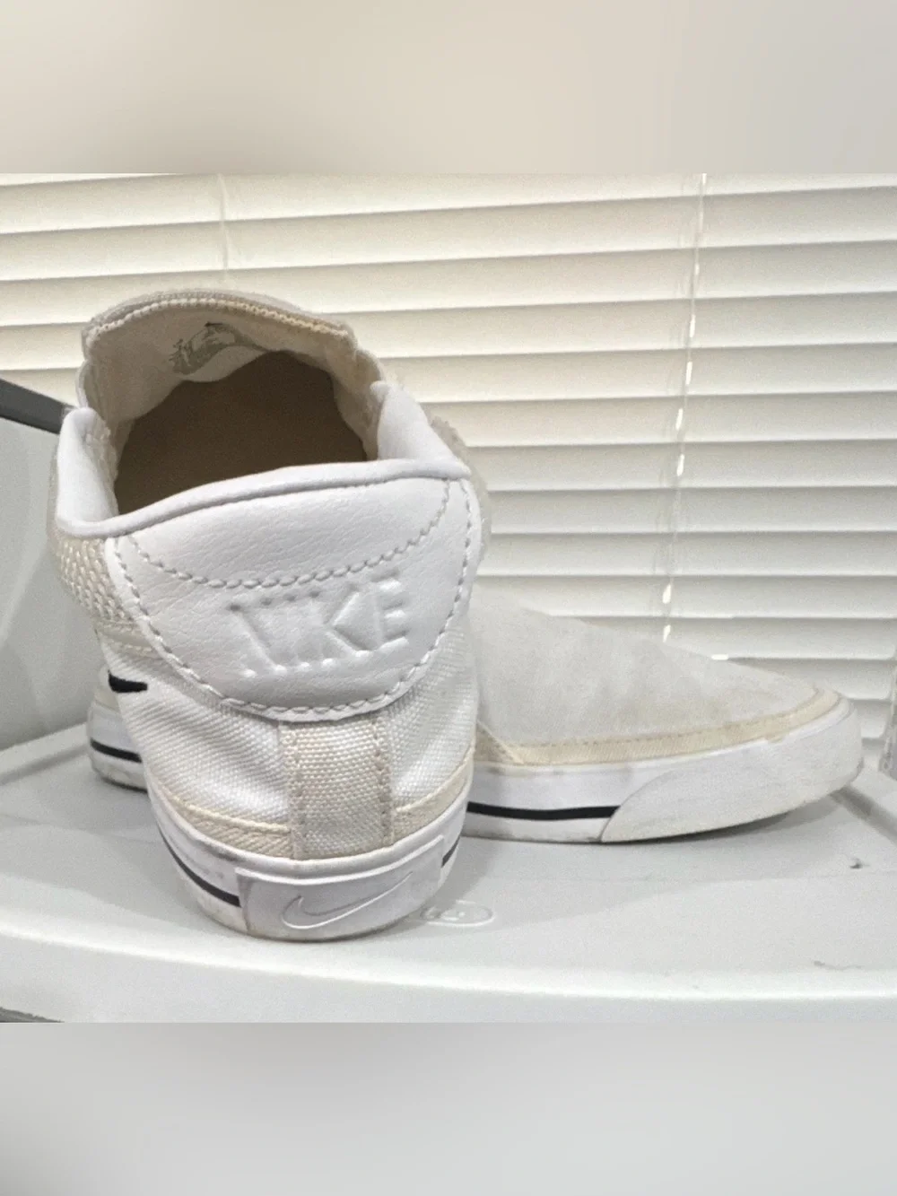 Nike Women’s White Slip-On Sneakers with Black Swoosh Accent